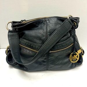 Michael Kors black leather zipper close bag. Very good pre-owned condition.